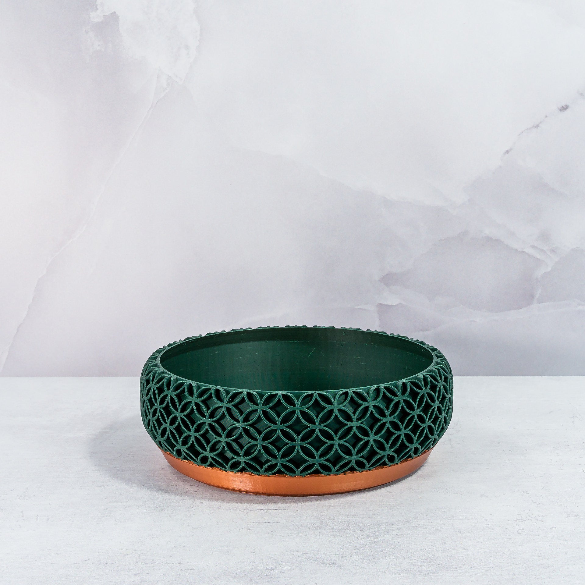 "Empty BLOSSOM bowl planter front view, showcasing copper base with intricate forest pattern."
