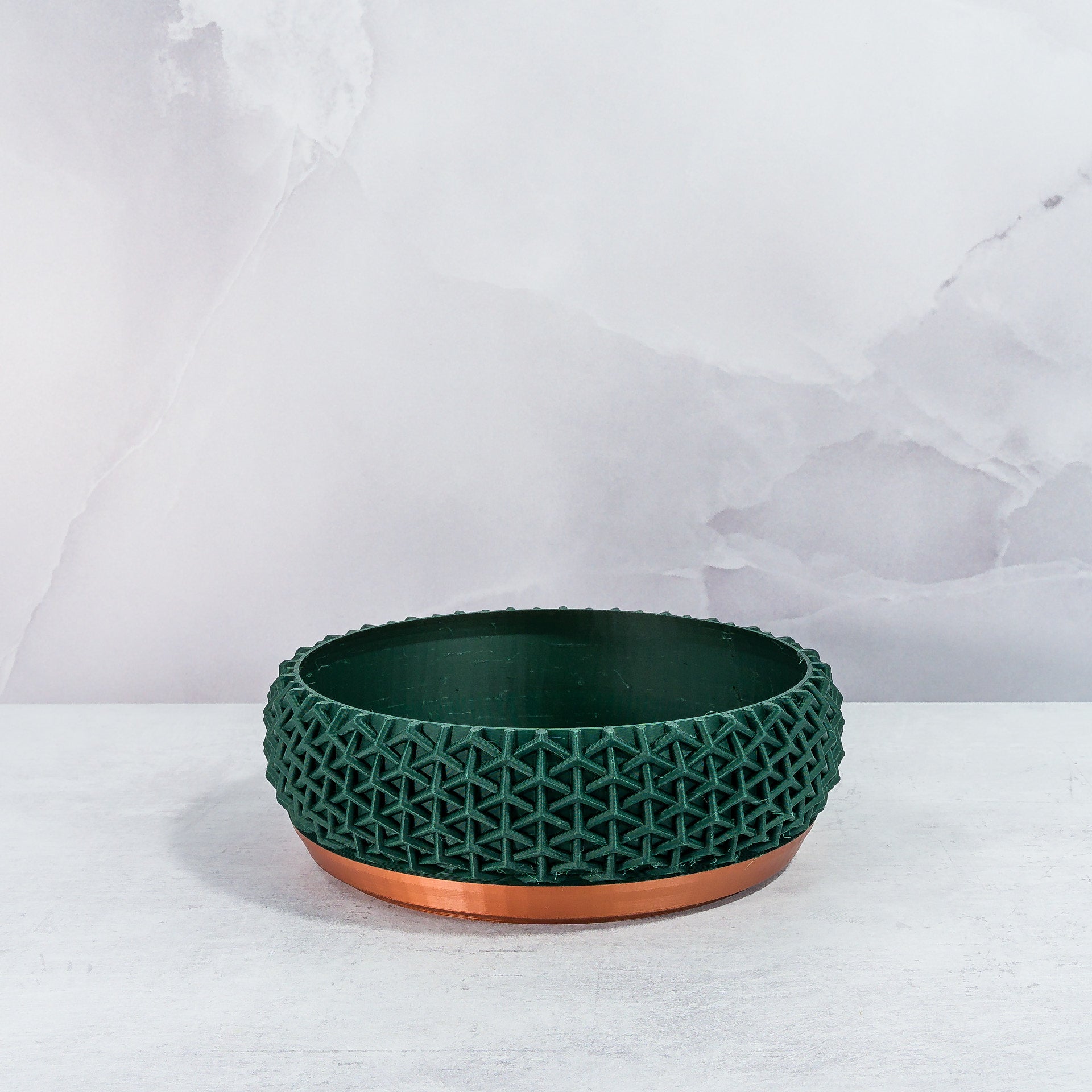 "Front view of empty STELLAR bowl planter with copper base and deep green forest pattern."
