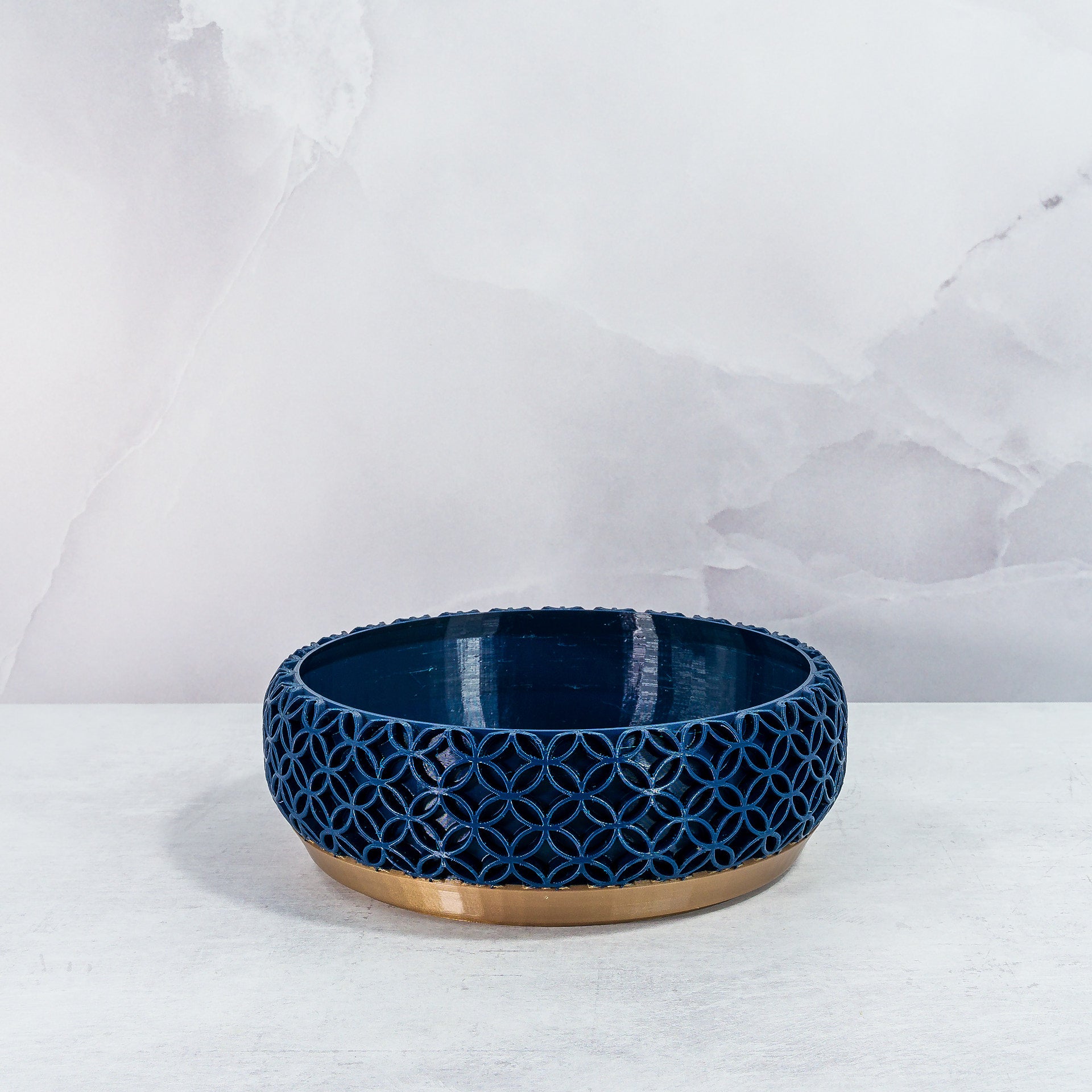 "Empty BLOSSOM bowl planter front view, showcasing gold base with intricate navy pattern."
