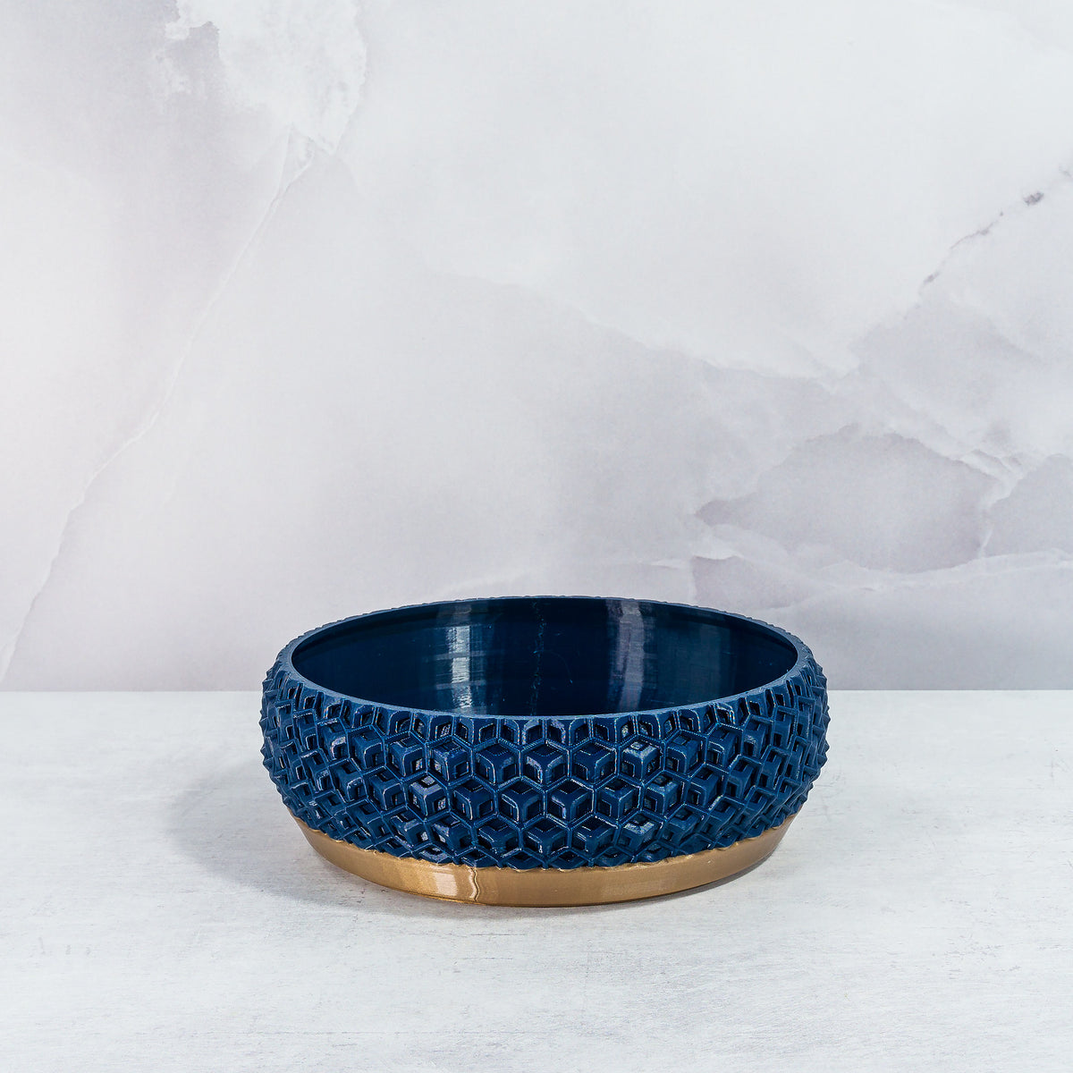 "Front view of empty TRANSFORM bowl planter with gold base and unique navy pattern."
