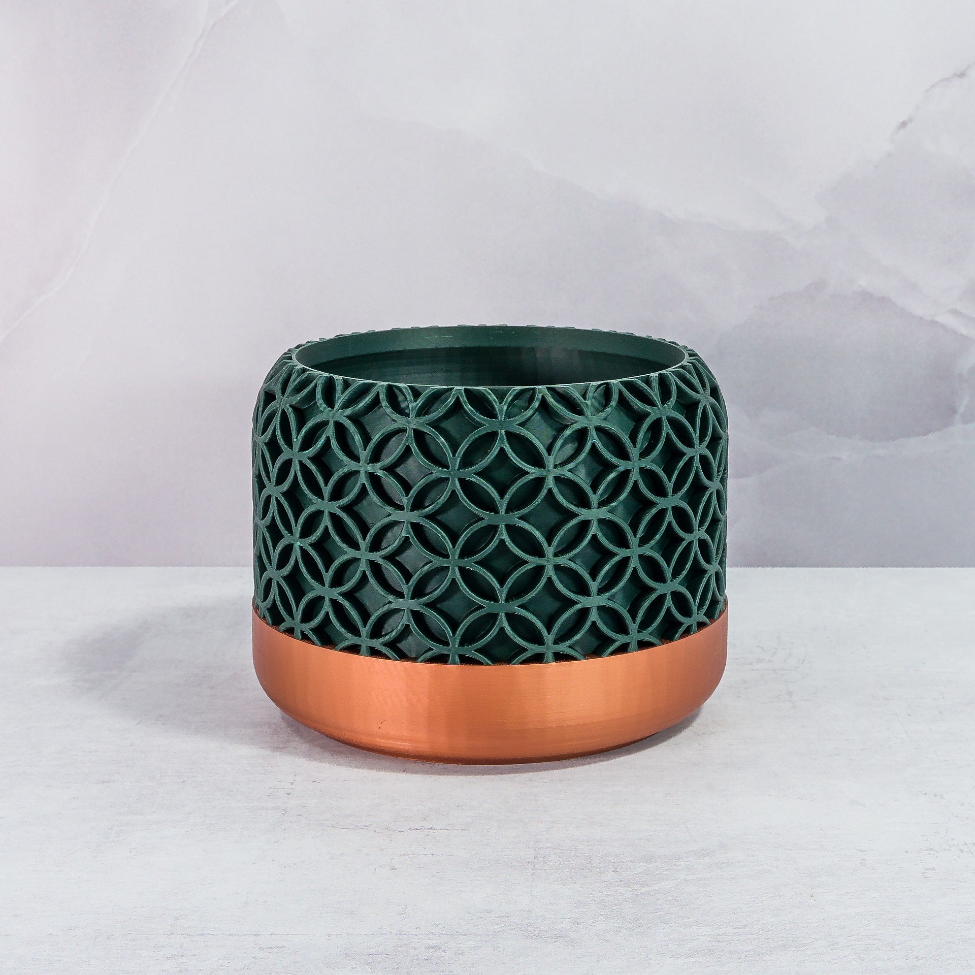 Front Facing: "BLOSSOM planter with copper base and deep green forest pattern, front view."
