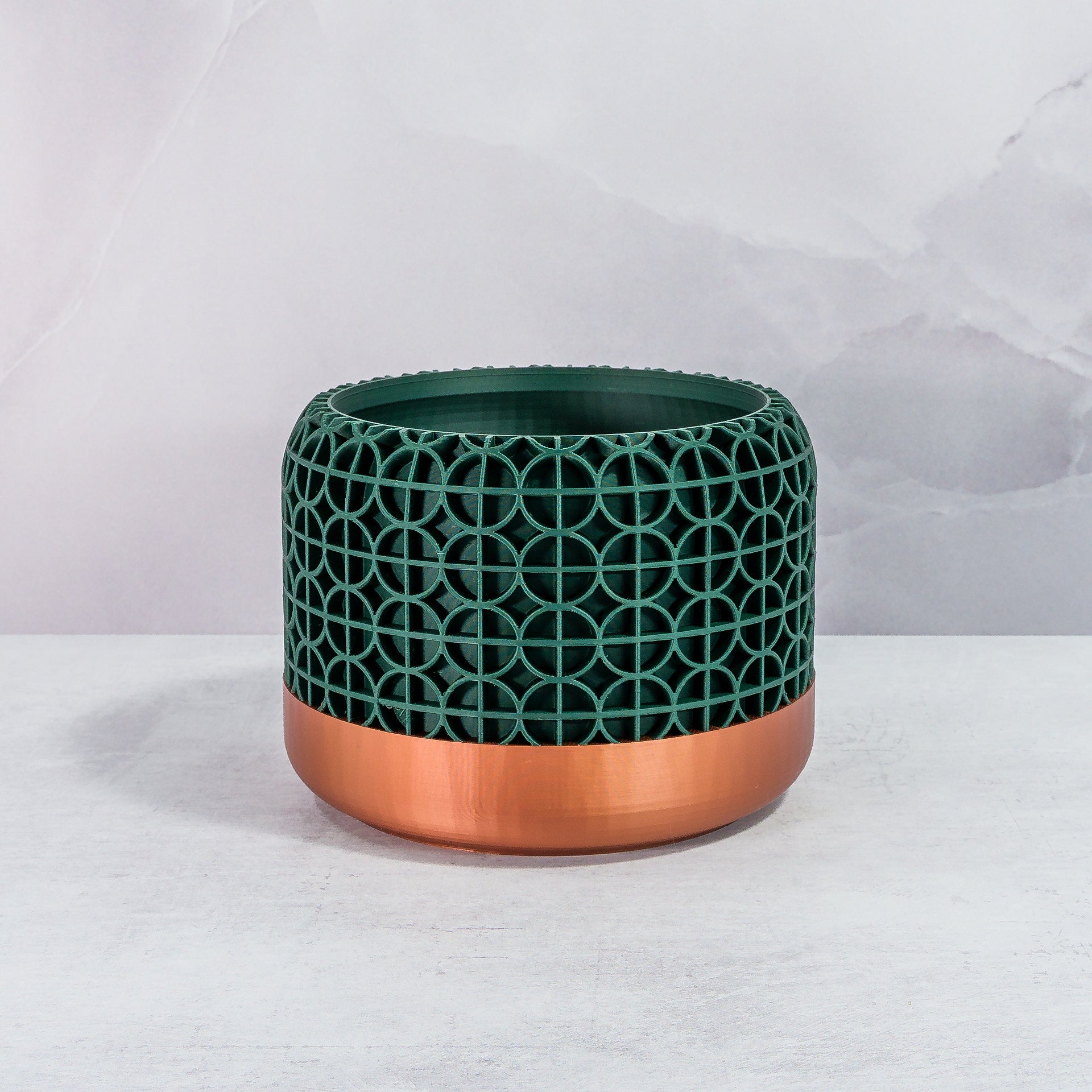 Front Facing: "CROSSORB planter with copper base and deep green forest pattern, front view."
