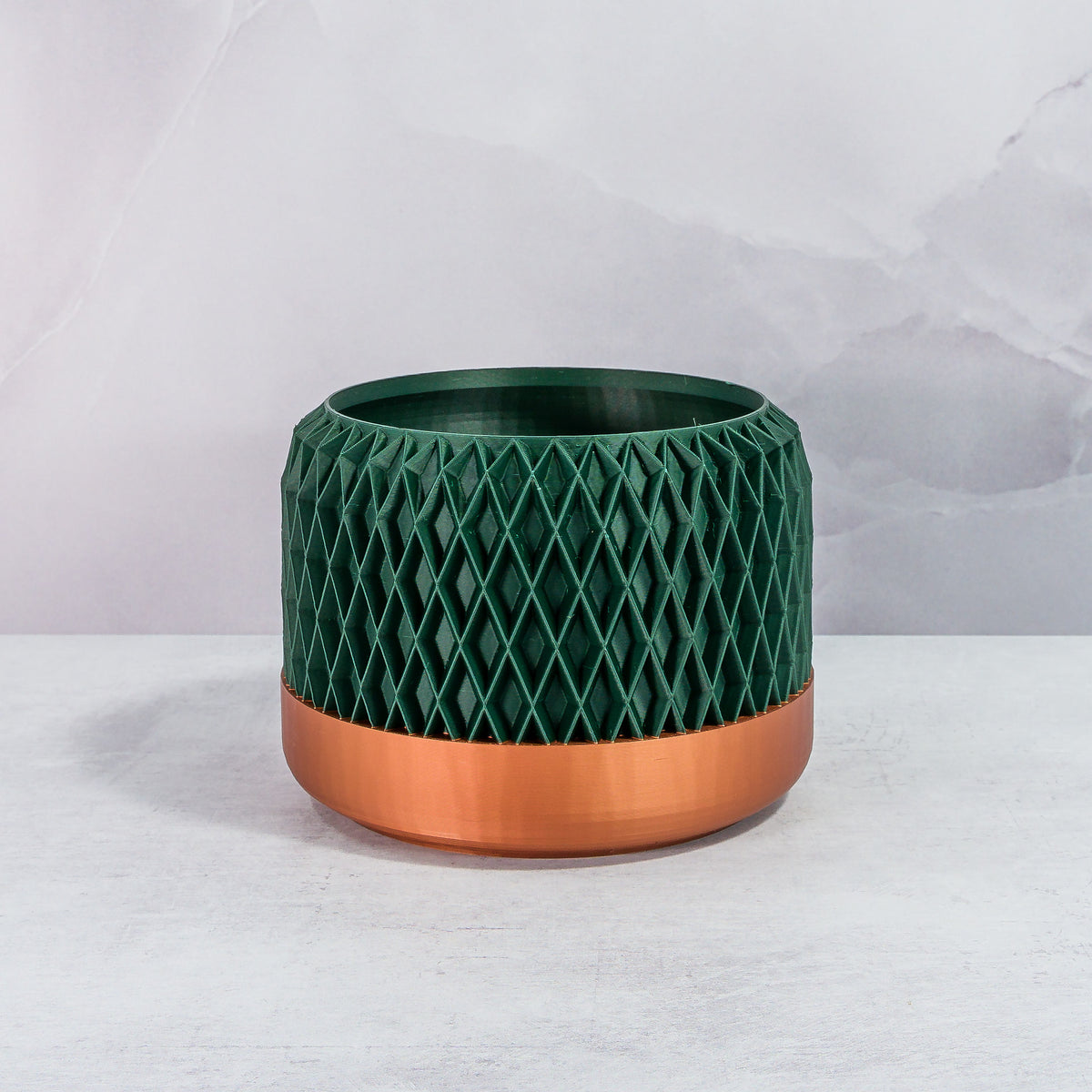 Front Facing: "DIAM planter with copper base and deep green forest pattern, front view."
