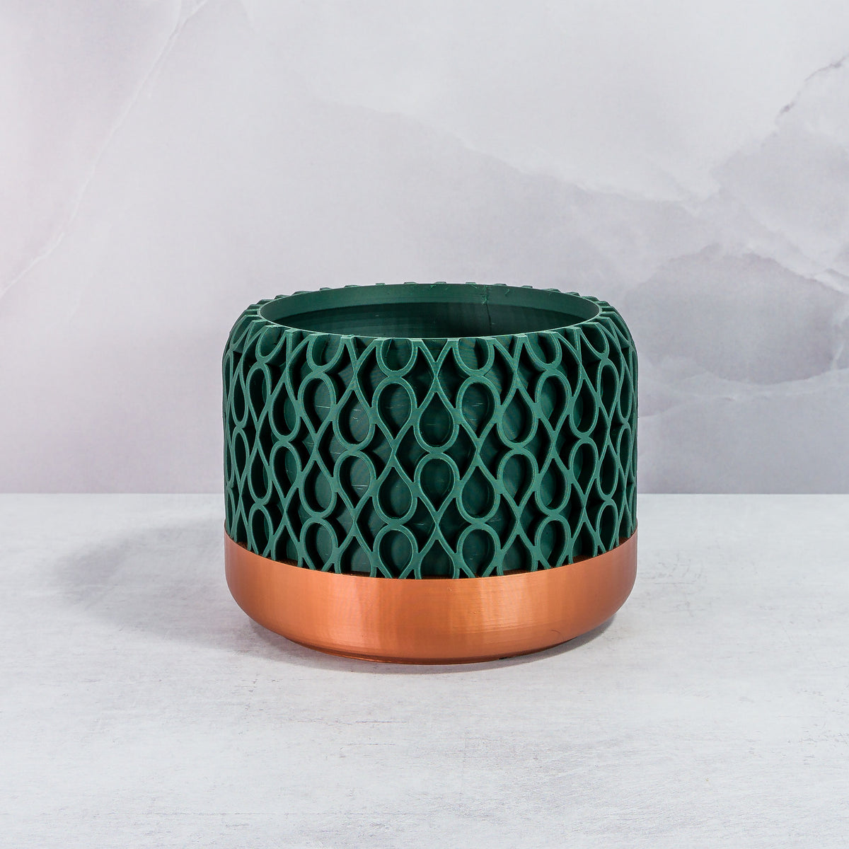 Front Facing: "DROPLET planter with copper base and deep green forest pattern, front view."
