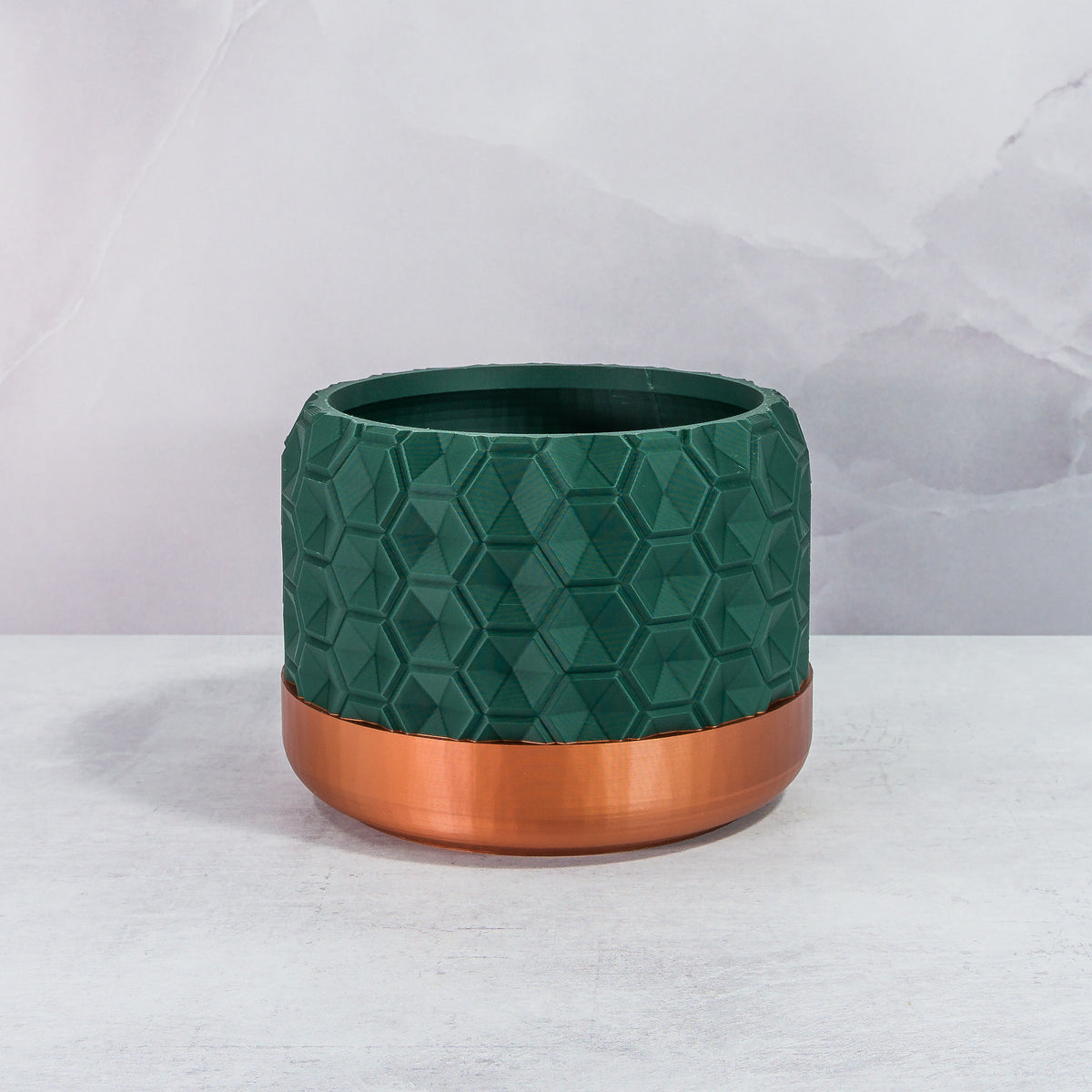 Front Facing: "HEXA planter with copper base and deep green forest pattern, front view."
