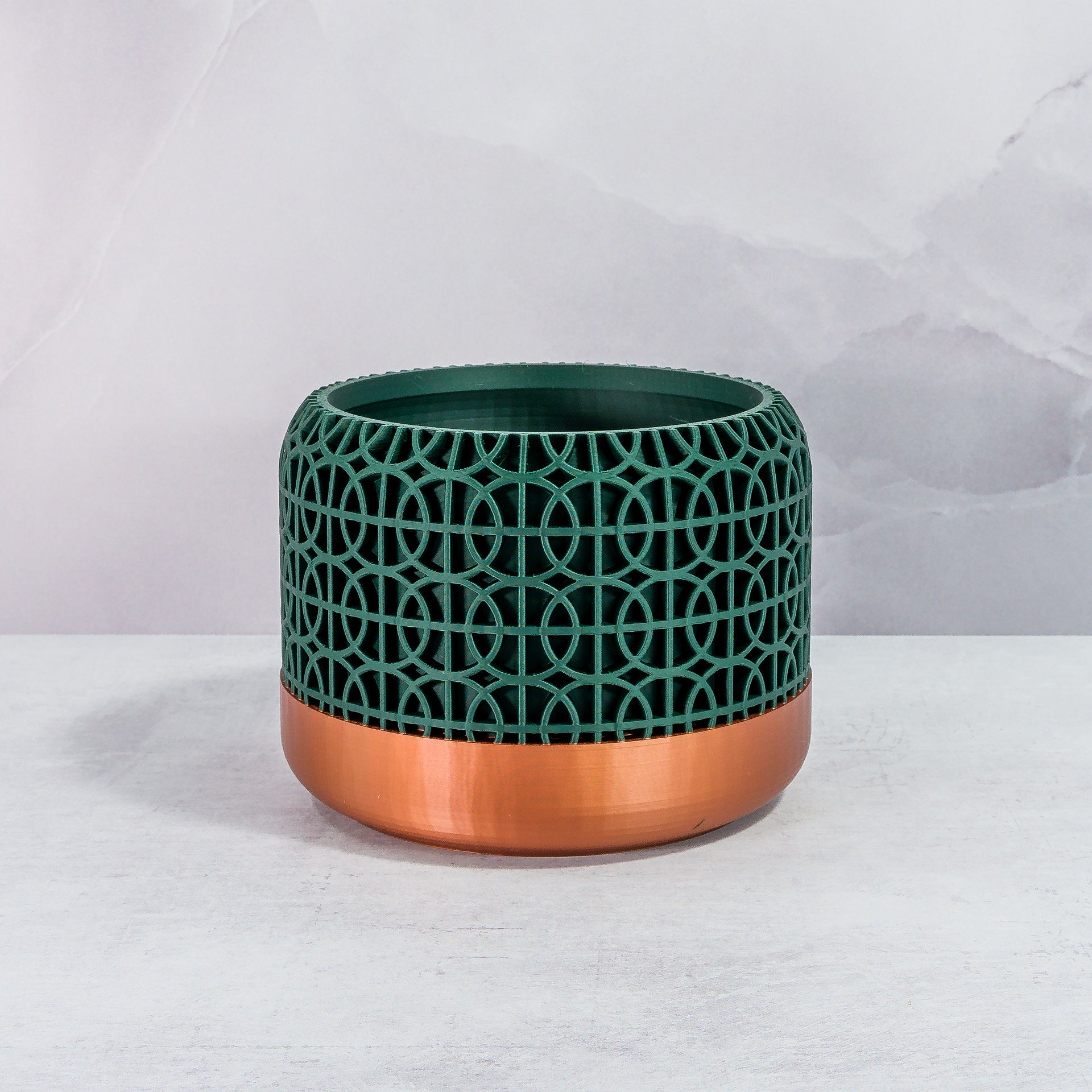 Front Facing: "INTERSECT planter with copper base and deep green forest pattern, front view."
