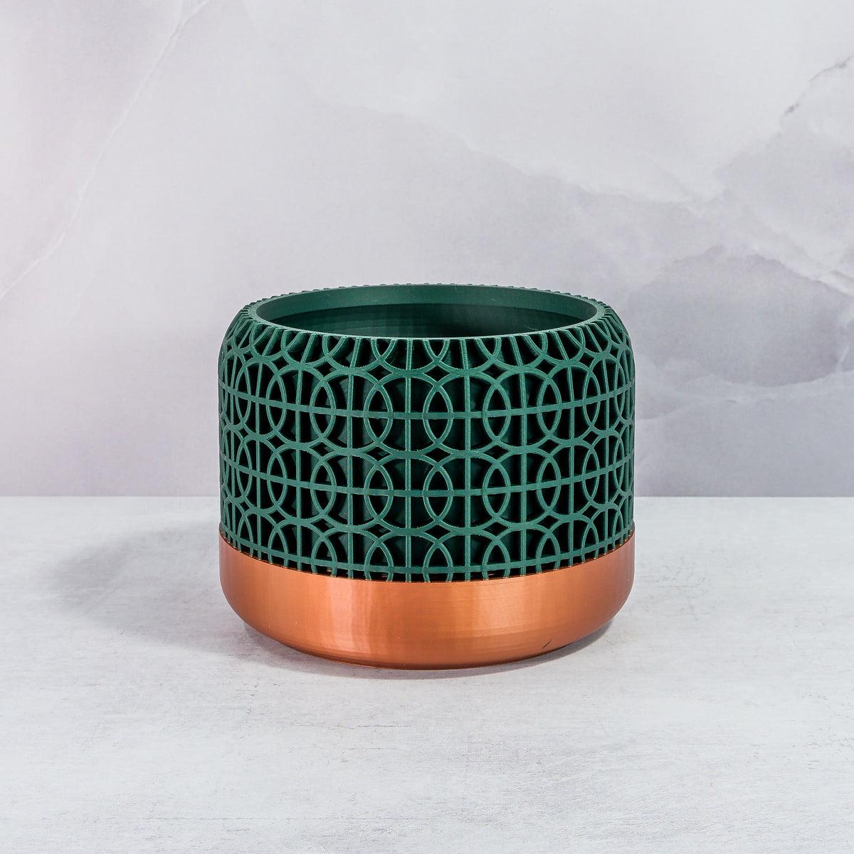 Front Facing: "INTERSECT planter with copper base and deep green forest pattern, front view."
