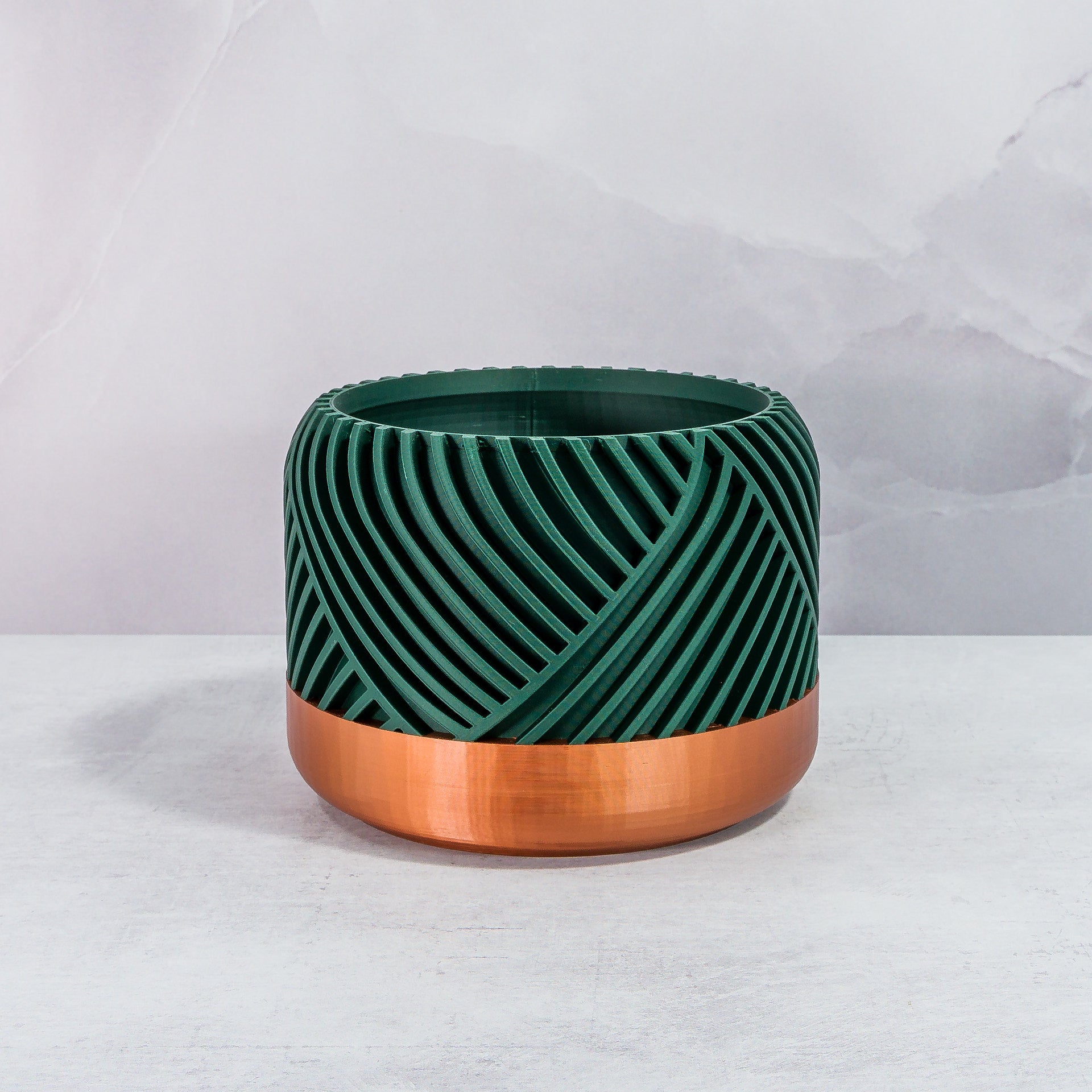 Front Facing: "PEAK planter with copper base and deep green forest pattern, front view."
