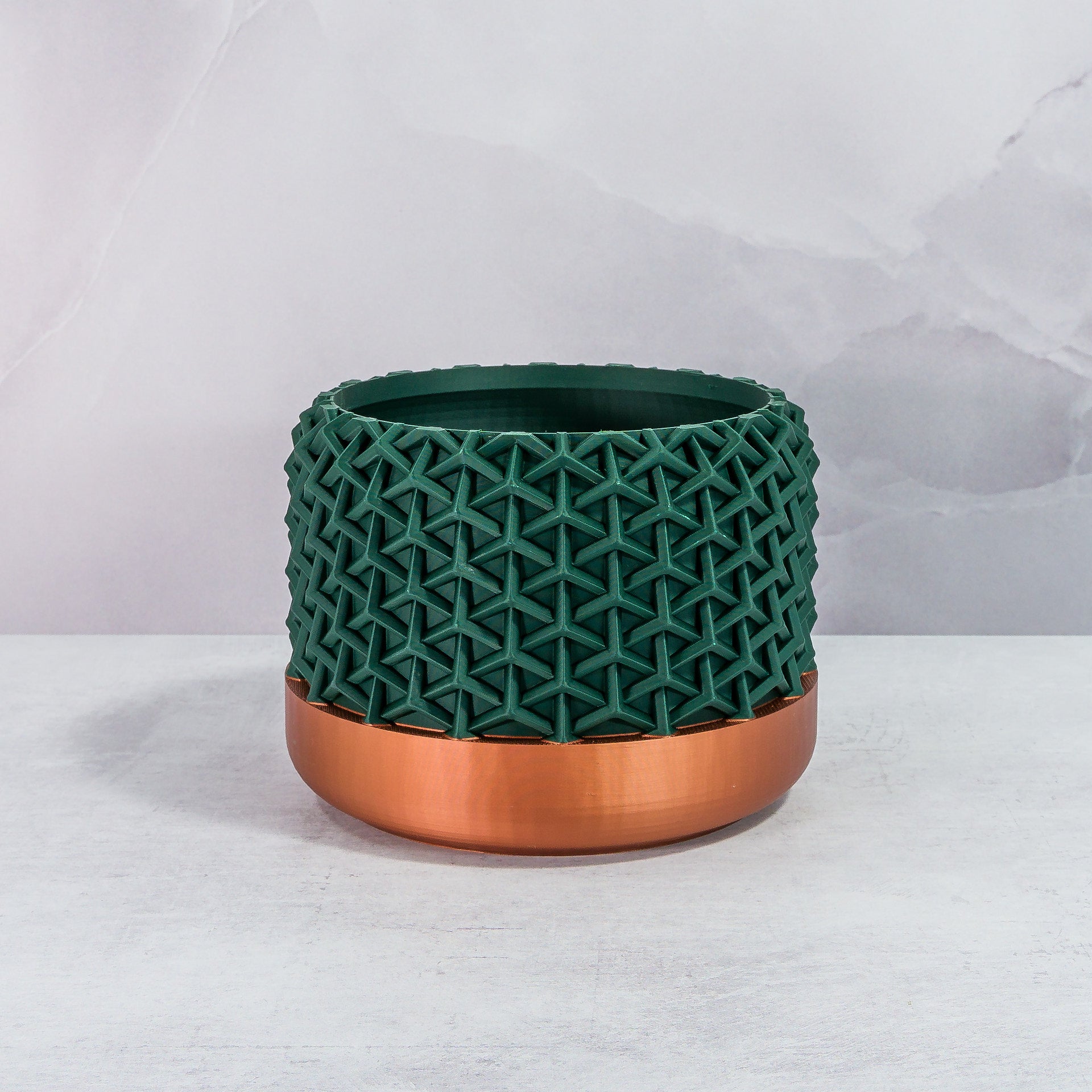 Front Facing: "STELLAR planter with copper base and deep green forest pattern, front view."
