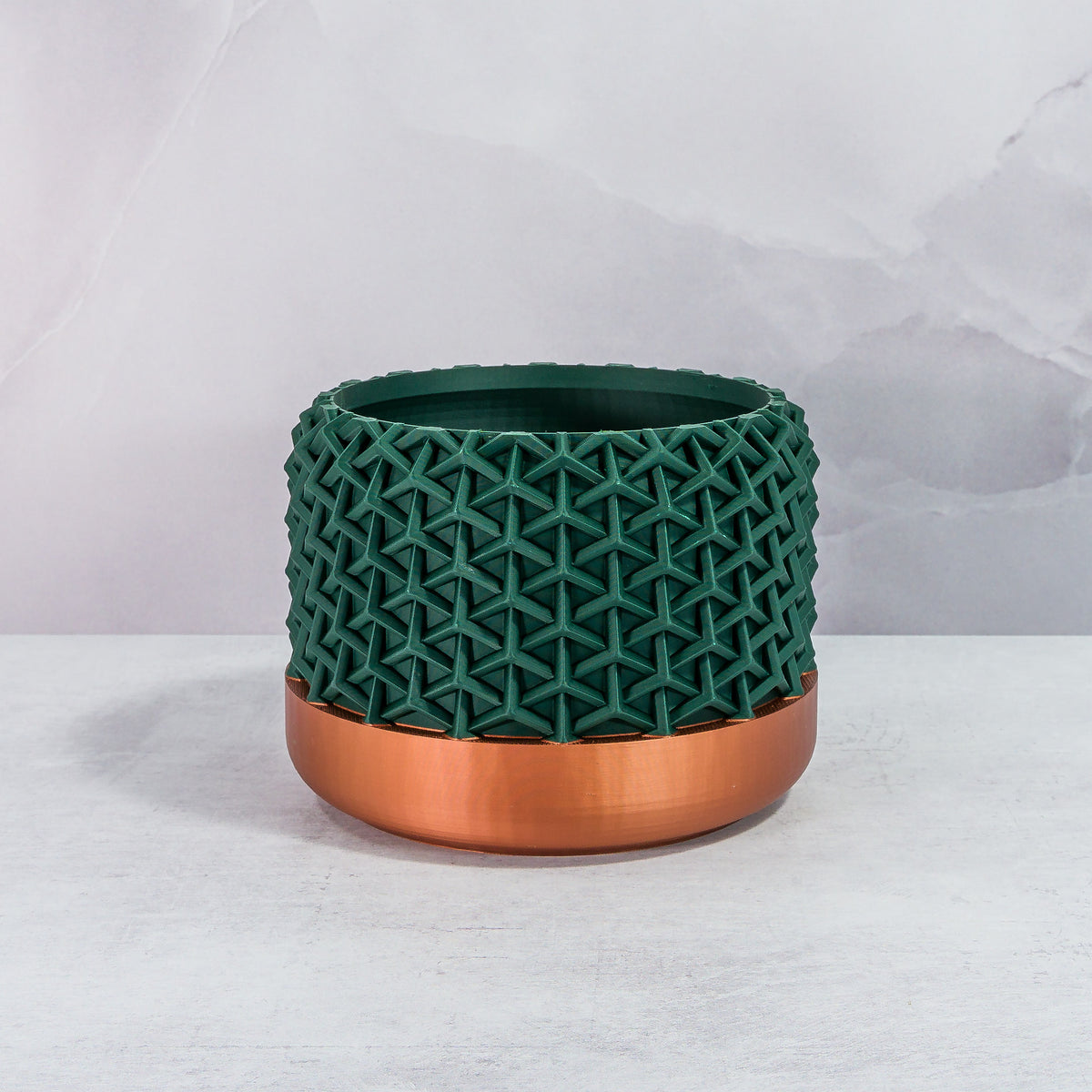 Front Facing: "STELLAR planter with copper base and deep green forest pattern, front view."
