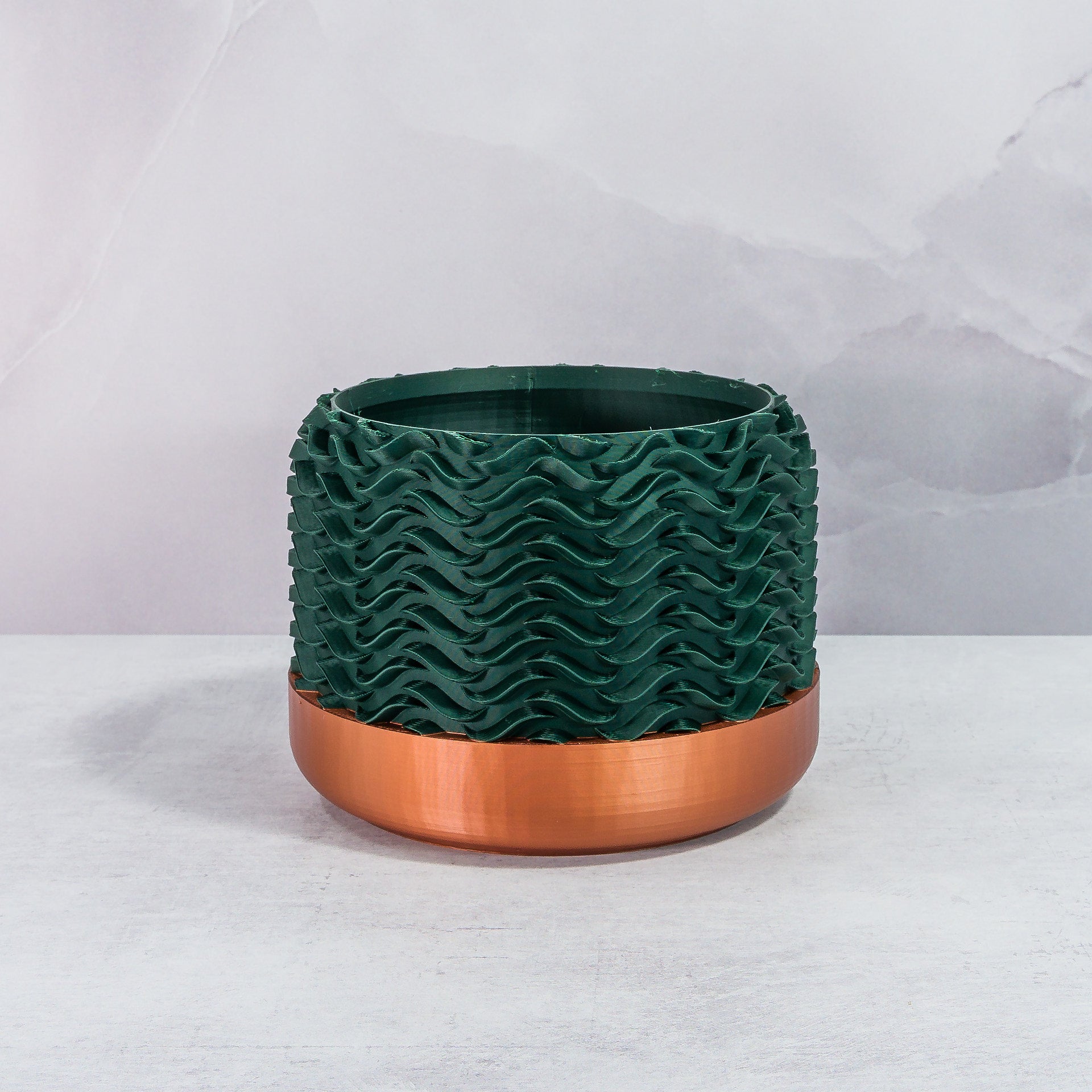 Front Facing: "TIDAL planter with copper base and deep green forest pattern, front view."
