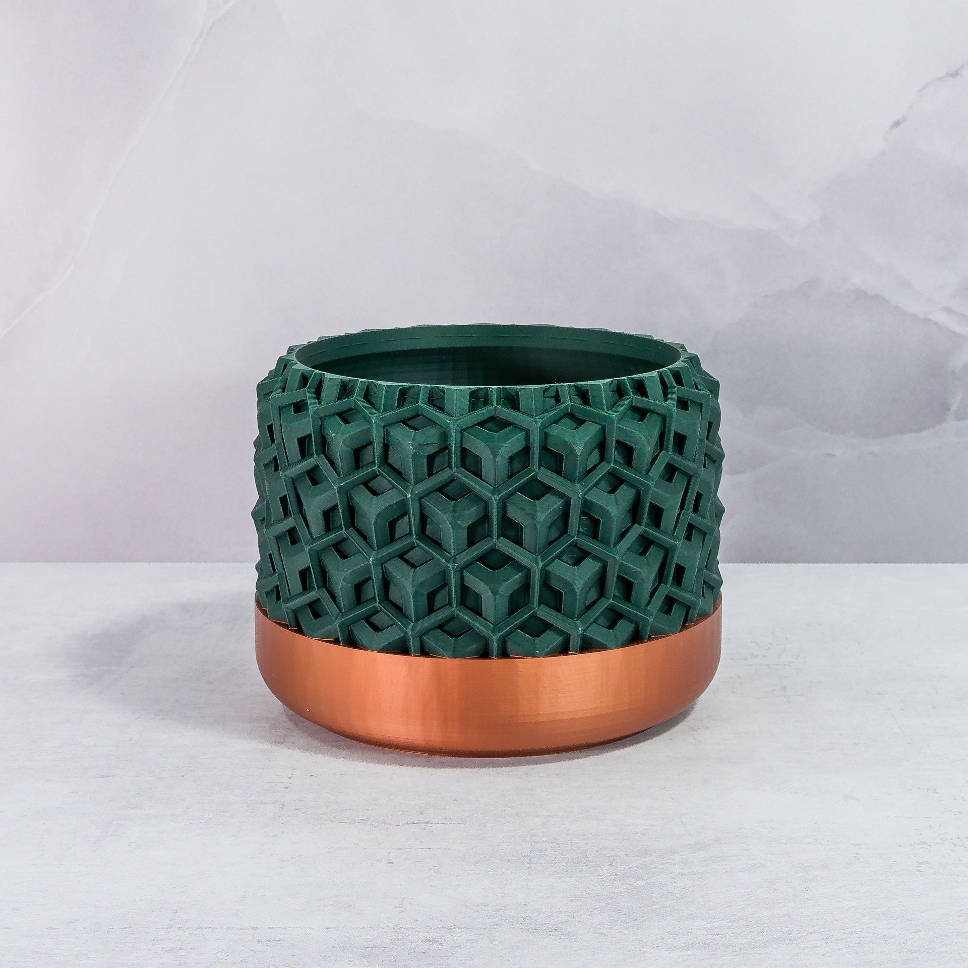 Front Facing: "TRANSFORM planter with copper base and deep green forest pattern, front view."
