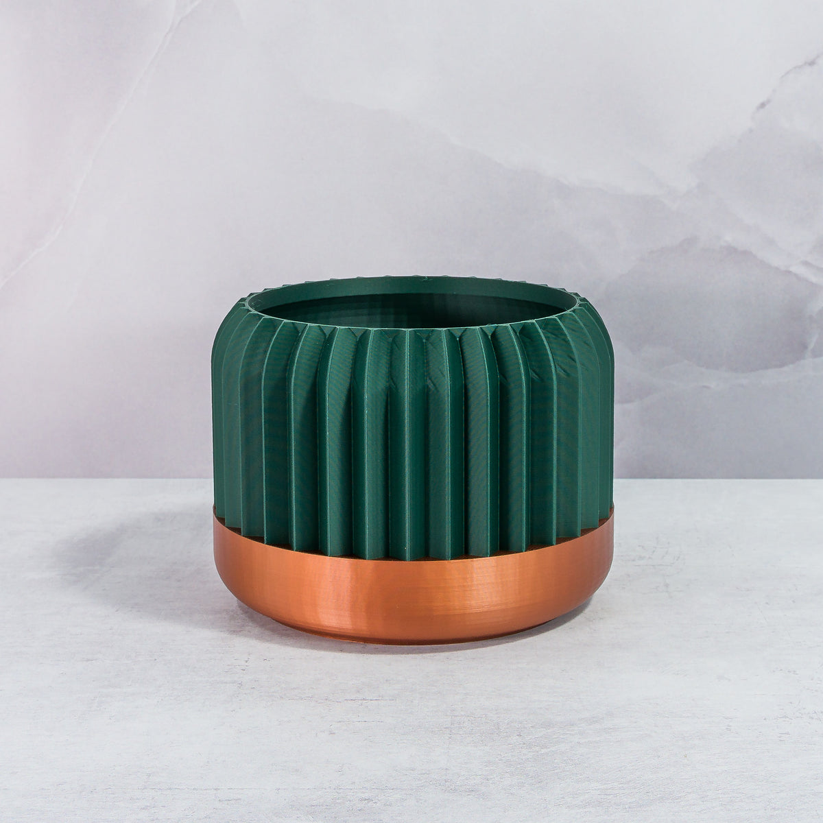 Front Facing: "TRILINEAR planter with copper base and deep green forest pattern, front view."
