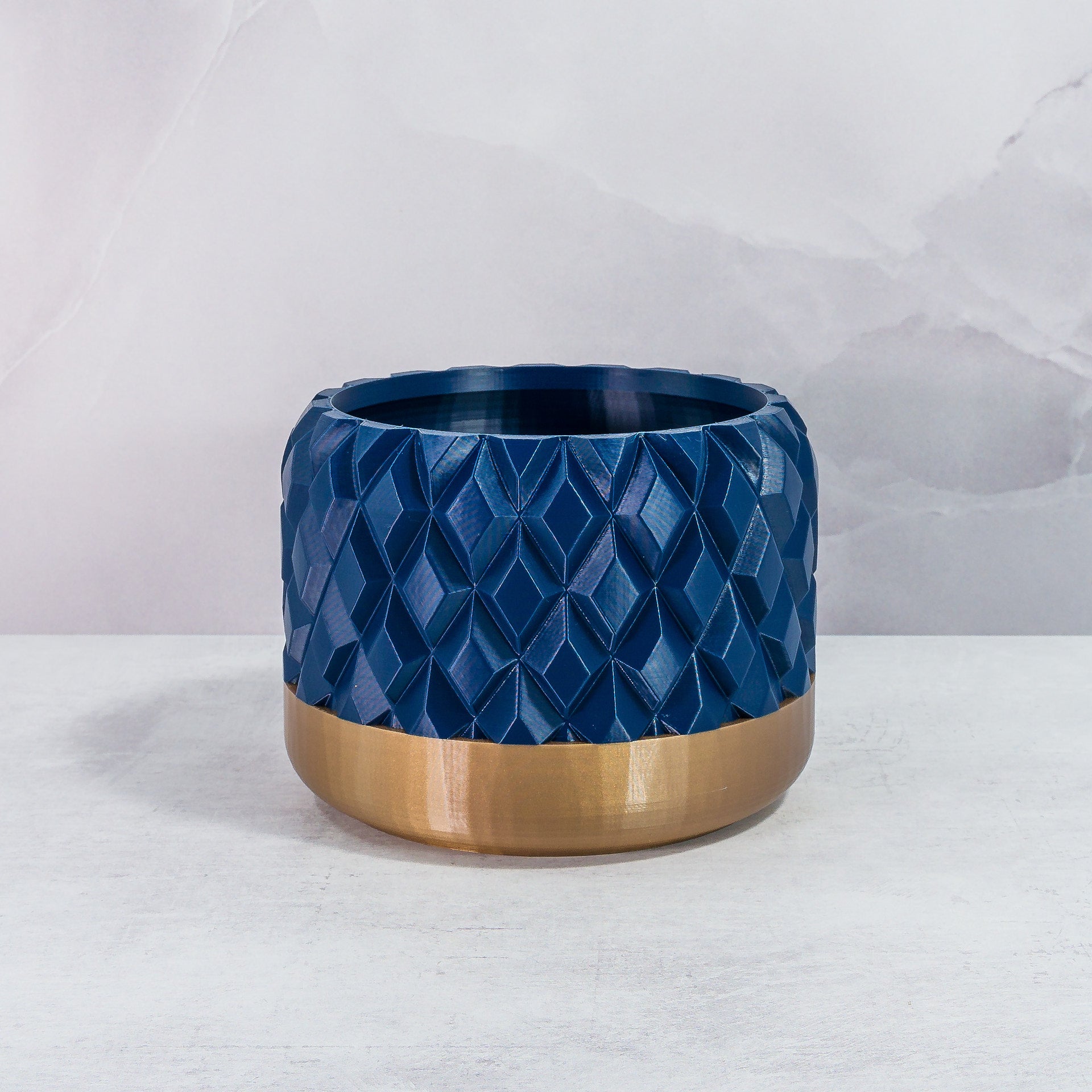 Front Facing: "GEM planter with gold base and navy pattern, front view."
