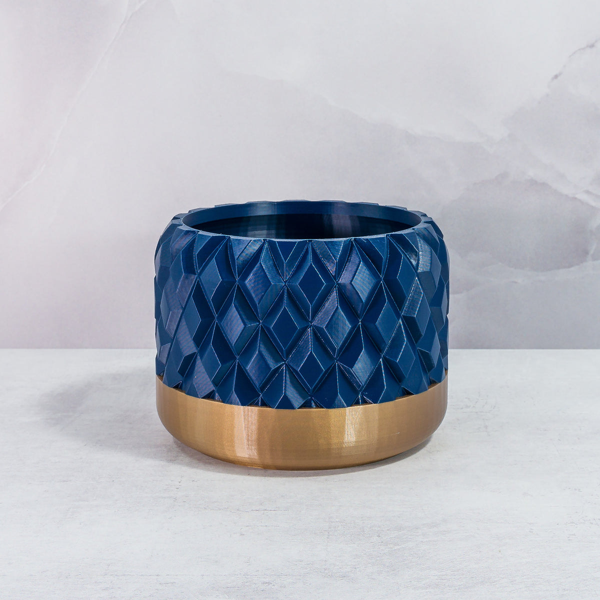 Front Facing: "GEM planter with gold base and navy pattern, front view."
