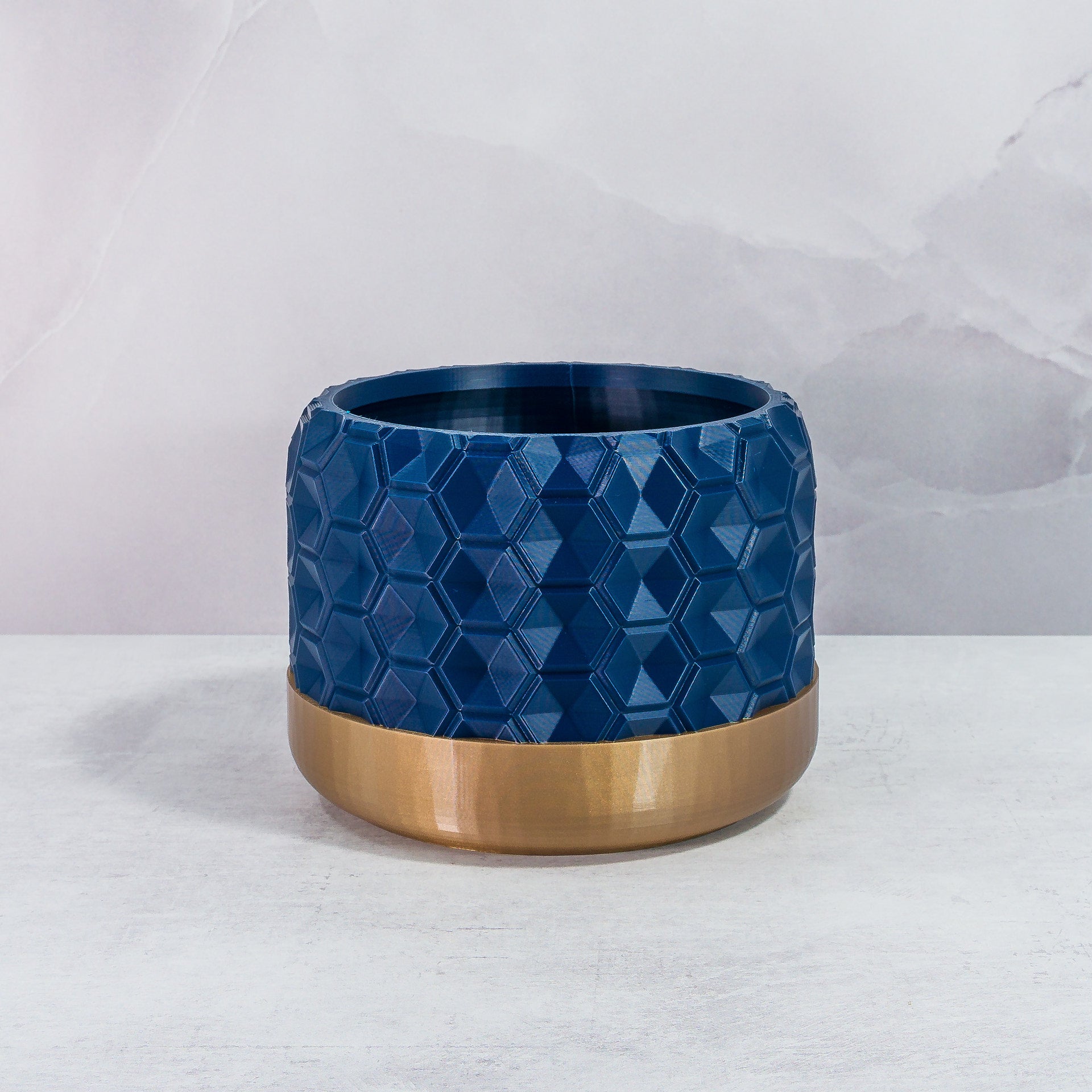 Front Facing: "HEXA planter with gold base and navy pattern, front view."
