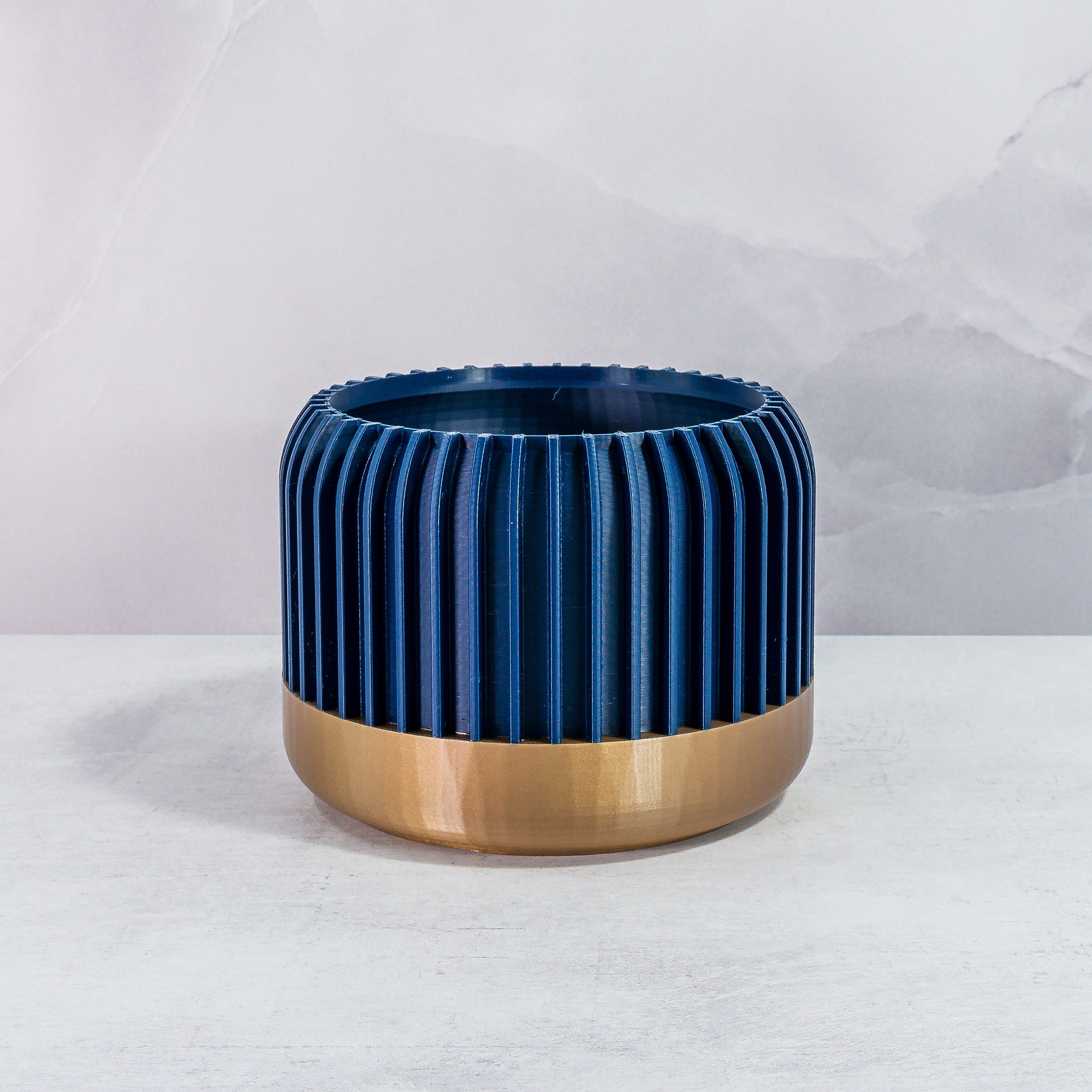 Front Facing: "LINEAR planter with gold base and navy pattern, front view."
