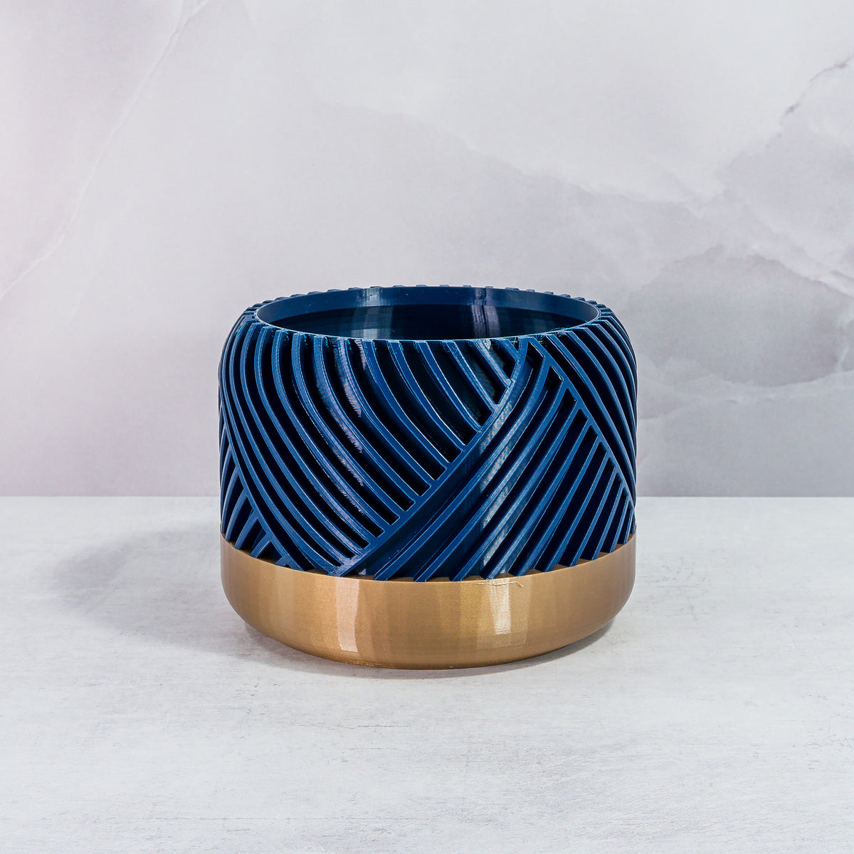 Front Facing: "PEAK planter with gold base and navy pattern, front view."
