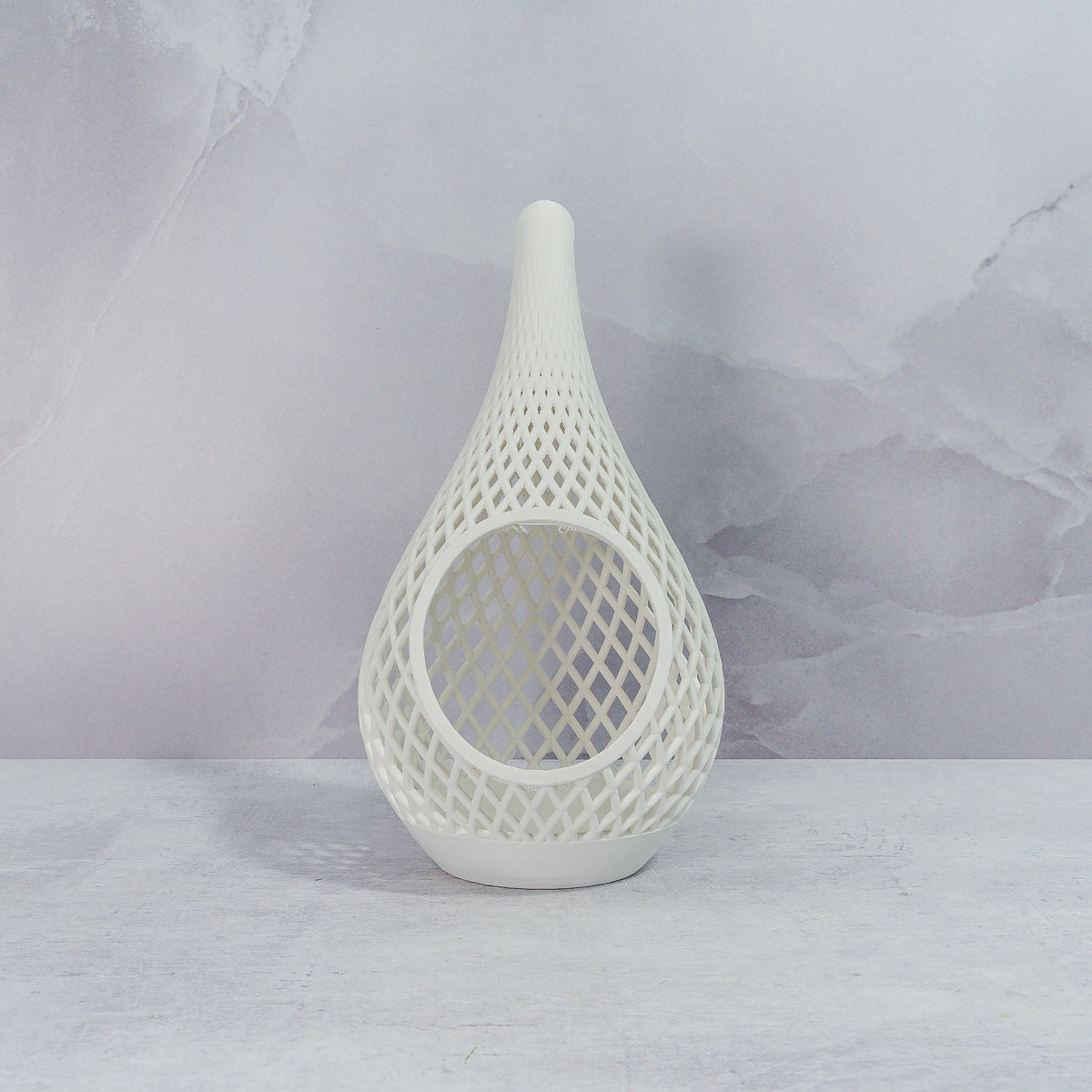 "Sitting, front-facing, empty MATTE WHITE TEARDROP planter, showcasing its minimalist design and clean, crisp finish."
