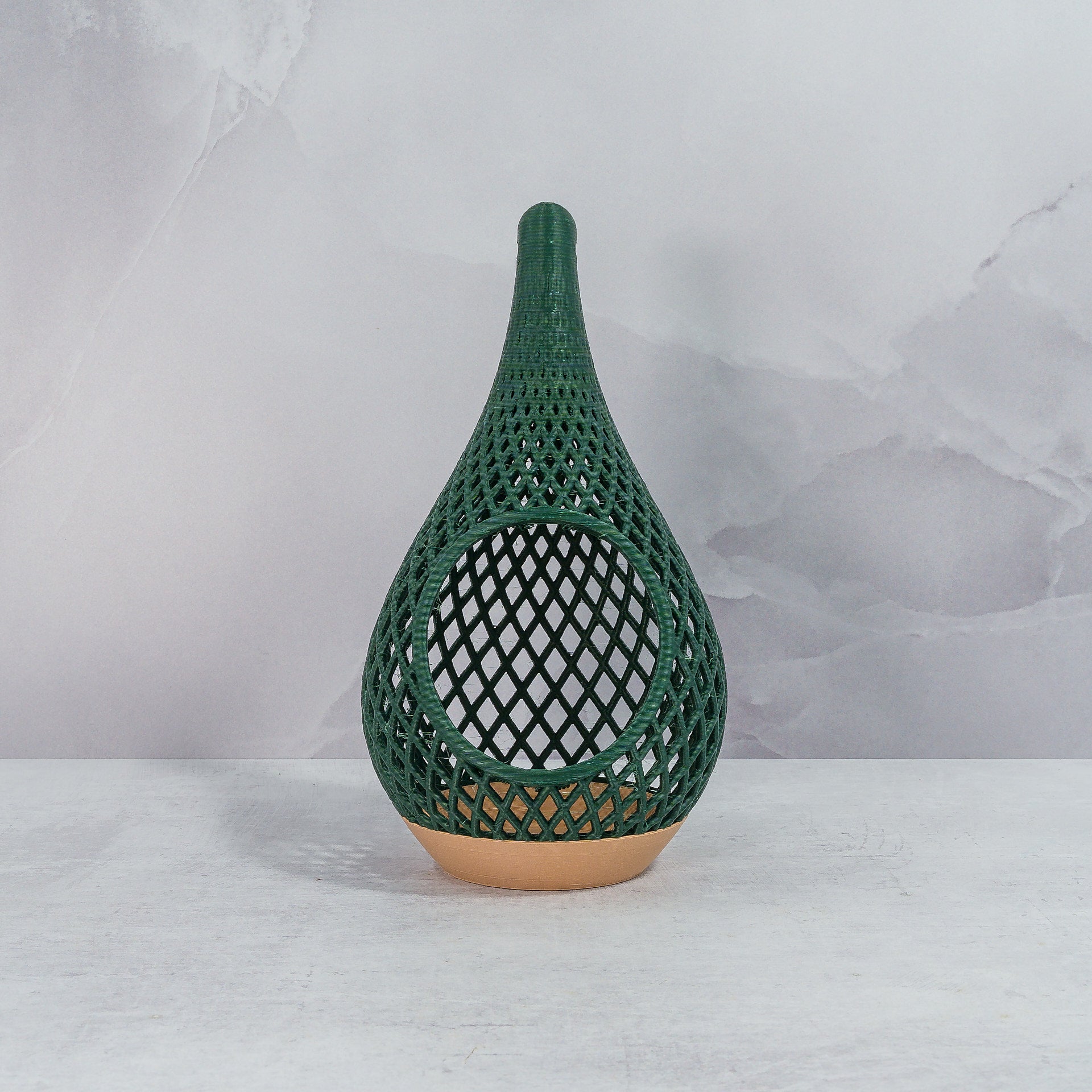 "Sitting, front-facing, empty WOOD AND GREEN TEARDROP planter, showcasing its natural wood base and refreshing green pattern."
