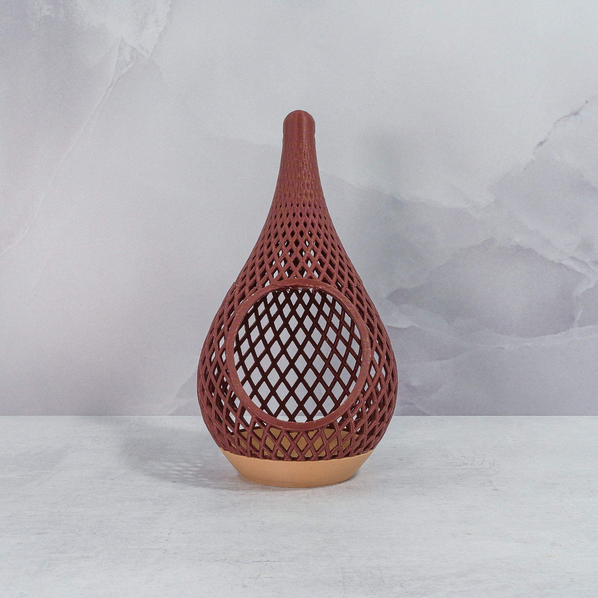 "Sitting, front-facing, empty WOOD AND RUBY RED TEARDROP planter, showcasing its elegant wood base and bold ruby red pattern."
