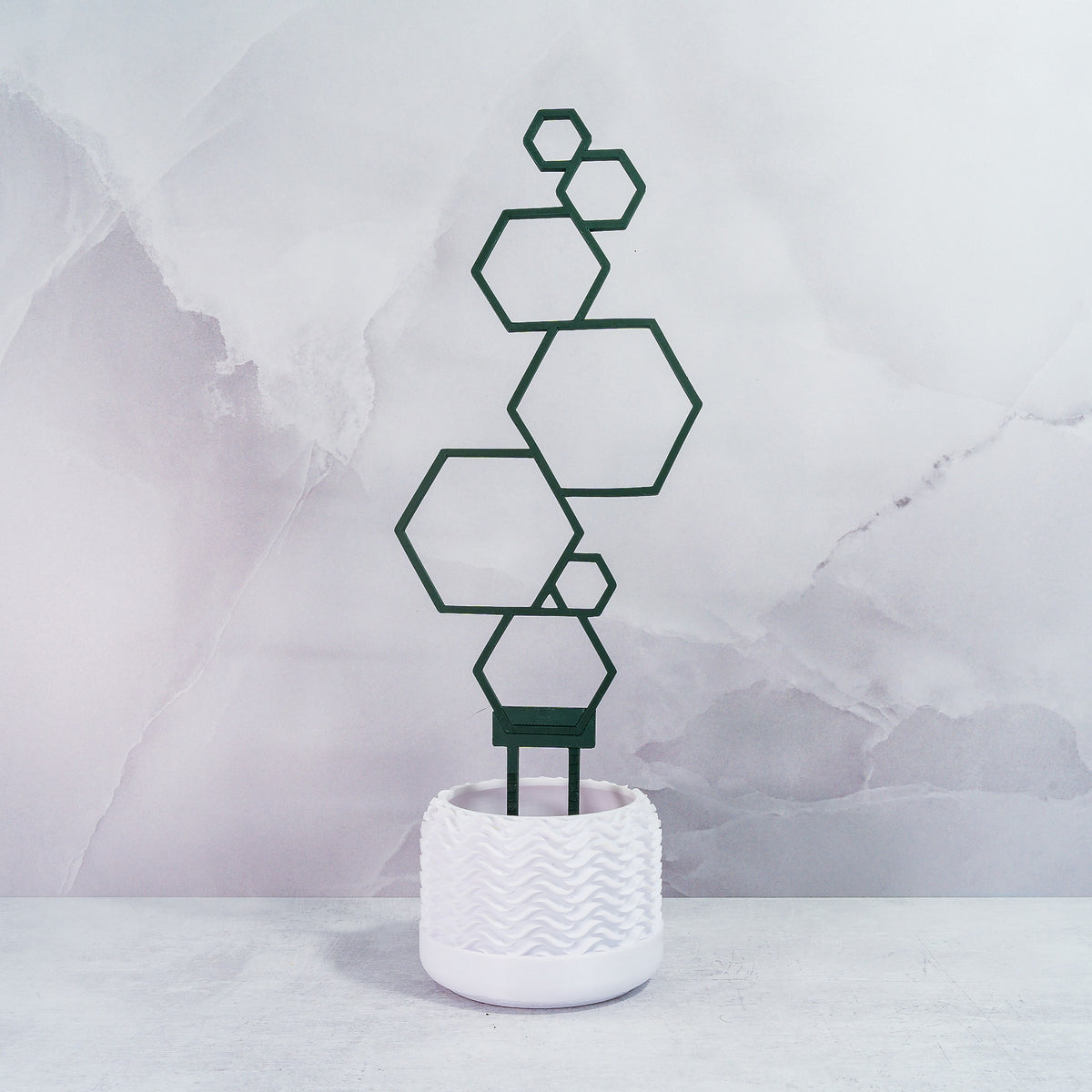 "Front view of FOREST GREEN Hexagons Trellis Spike, displaying geometric tower design without plants."
